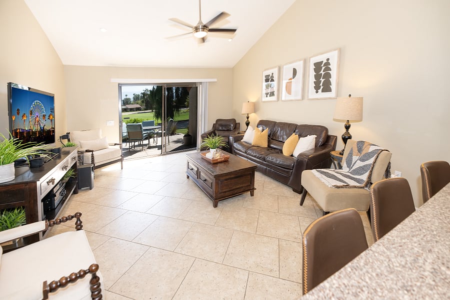 Kitchen opens to living room with views of the mountains and golf course