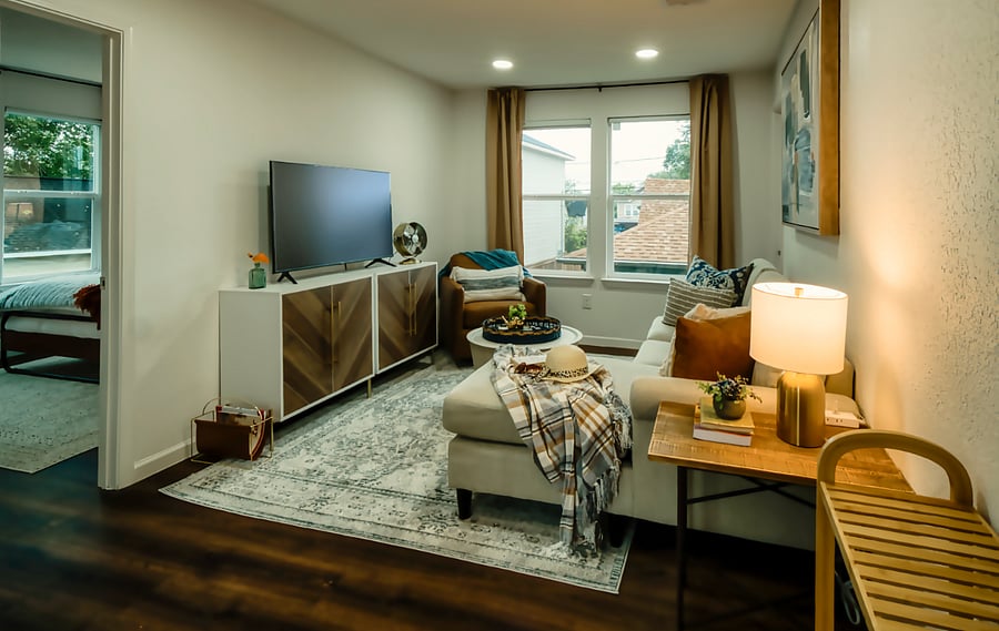 Spacious couch and low profile chair in living room.