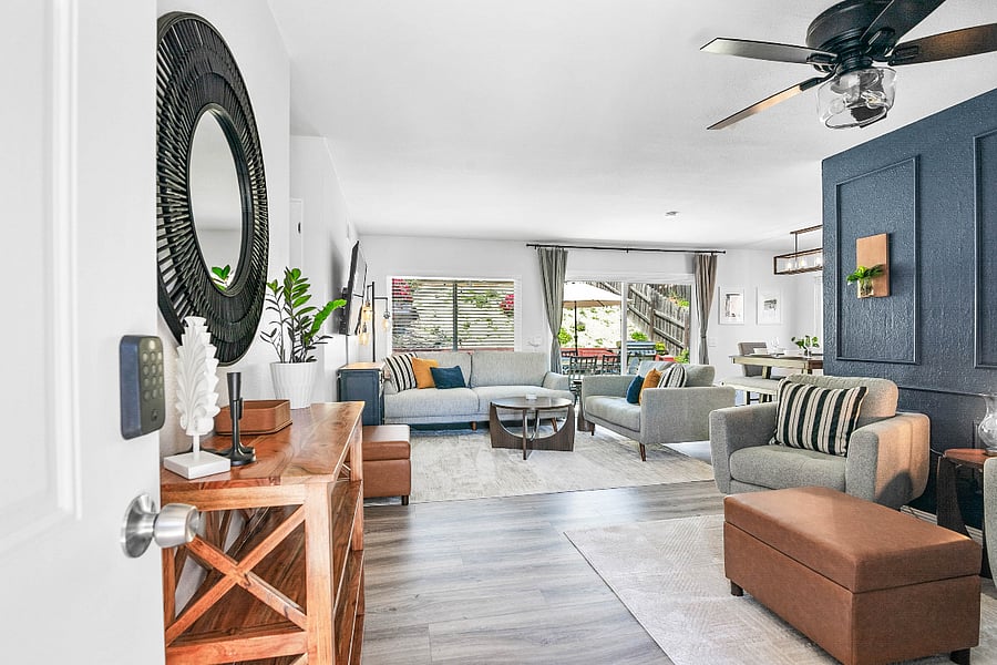 Entrance into the home from the front door, showcasing ample seating with both a living room and seating/reading area.