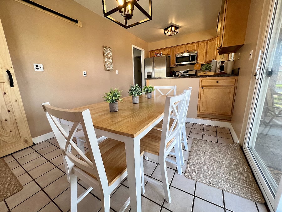 Dining area with seating for 6 and doorwall to covered patio