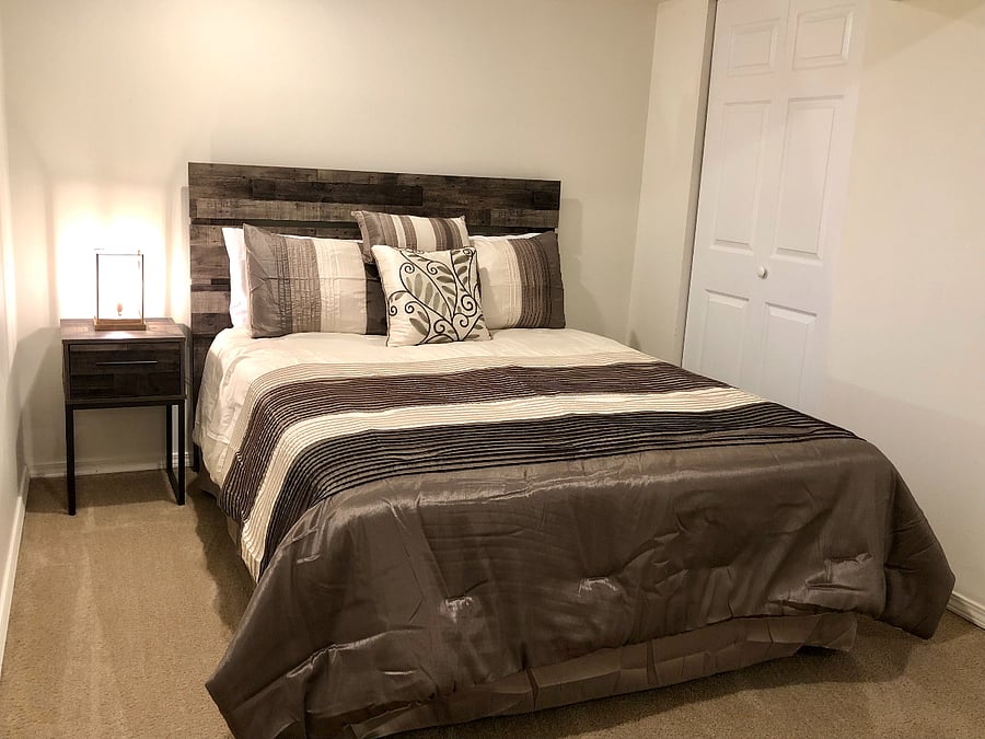 Bedroom in basement with queen bed
