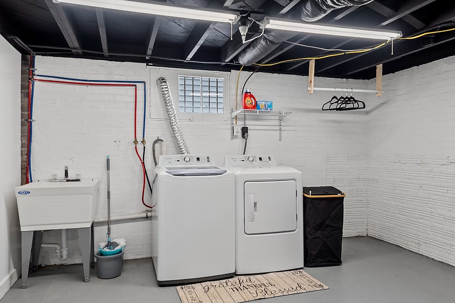 Laundry with a utility sink and an area for hanging clothes