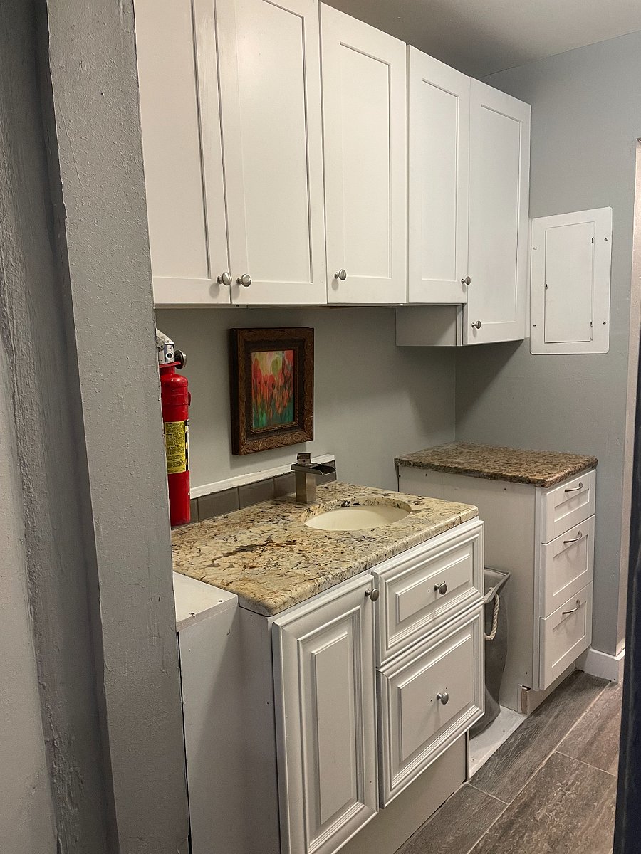 laundry area with storage and sink