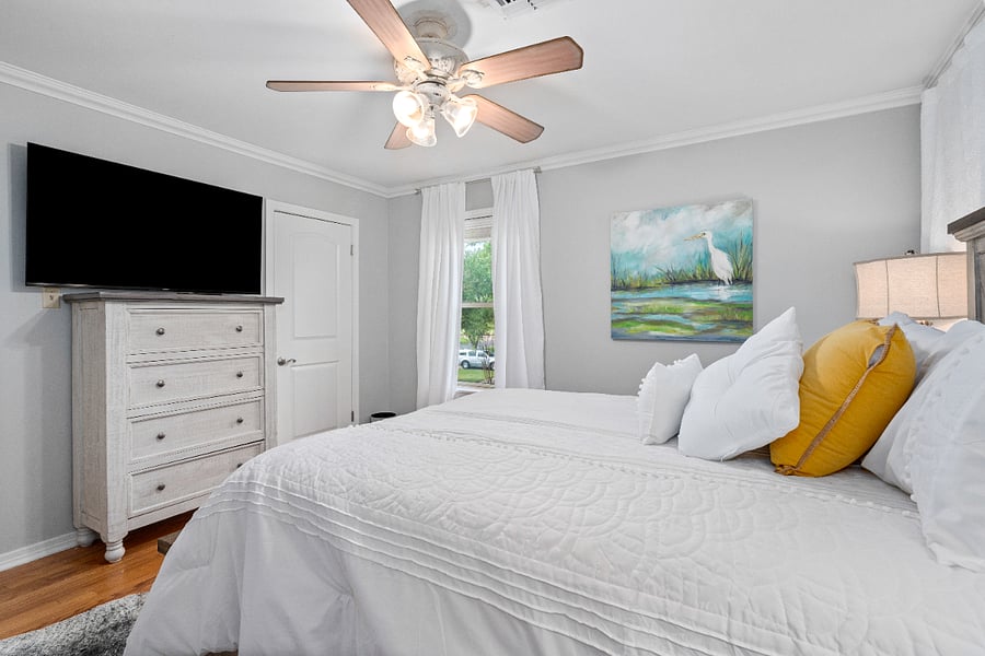 Bedroom with queen sized bed. Smart TV. Closet and dresser storage.