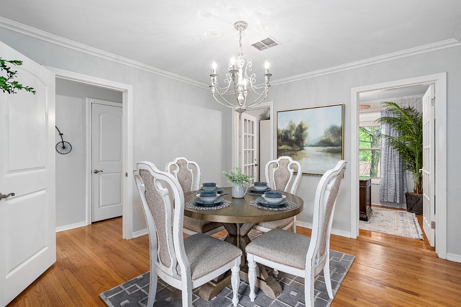 Dining room with table and chairs. Adjacent to kitchen and living room.