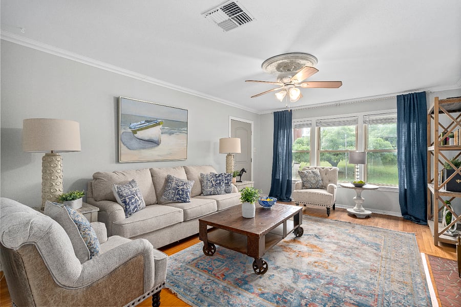 Living room area showing the large windows for extra light. All windows have wooden blinds and drapes for privacy.