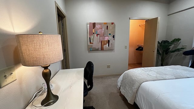 Bedroom 1.
With walk in closet, attached bath, queen bed, desk, and outside balcony.