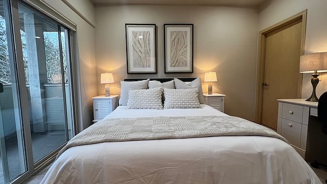 Bedroom 1.
With walk in closet, attached bath, queen bed, desk, and outside balcony.