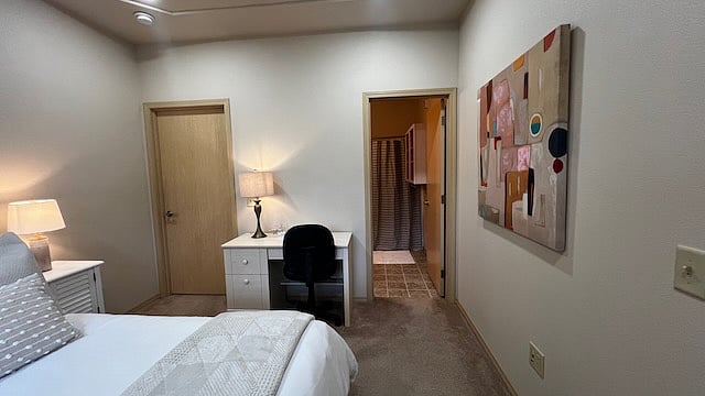 Bedroom 1.
With walk in closet, attached bath, queen bed, desk, and outside balcony.