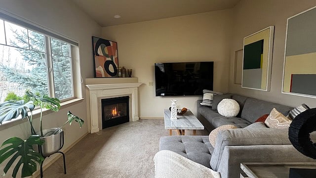 Great room / Living room with cozy sectional sofa, 73 inch smart TV, WiFi. Attached to kitchen, dinning room, and external patio.