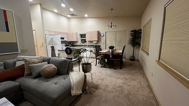 Great room / Living room with cozy sectional sofa, 73 inch smart TV, WiFi. Attached to kitchen, dinning room, and external patio.
