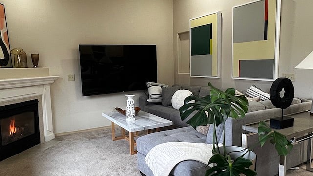 Great room / Living room with cozy sectional sofa, 73 inch smart TV, WiFi. Attached to kitchen, dinning room, and external patio.