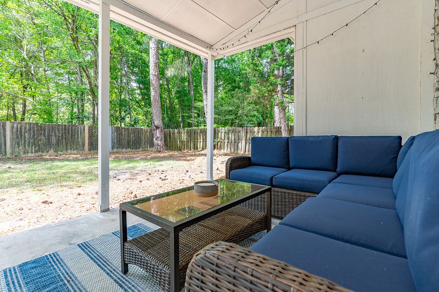 Step outside to a covered patio with a comfortable outdoor sectional, ideal for enjoying your morning coffee or unwinding in the evening. The fully fenced backyard offers complete privacy.