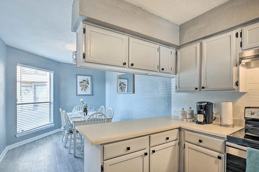 The open plan kitchen flows into the dining room with comfortable seating for 6 and tons of natural light.
