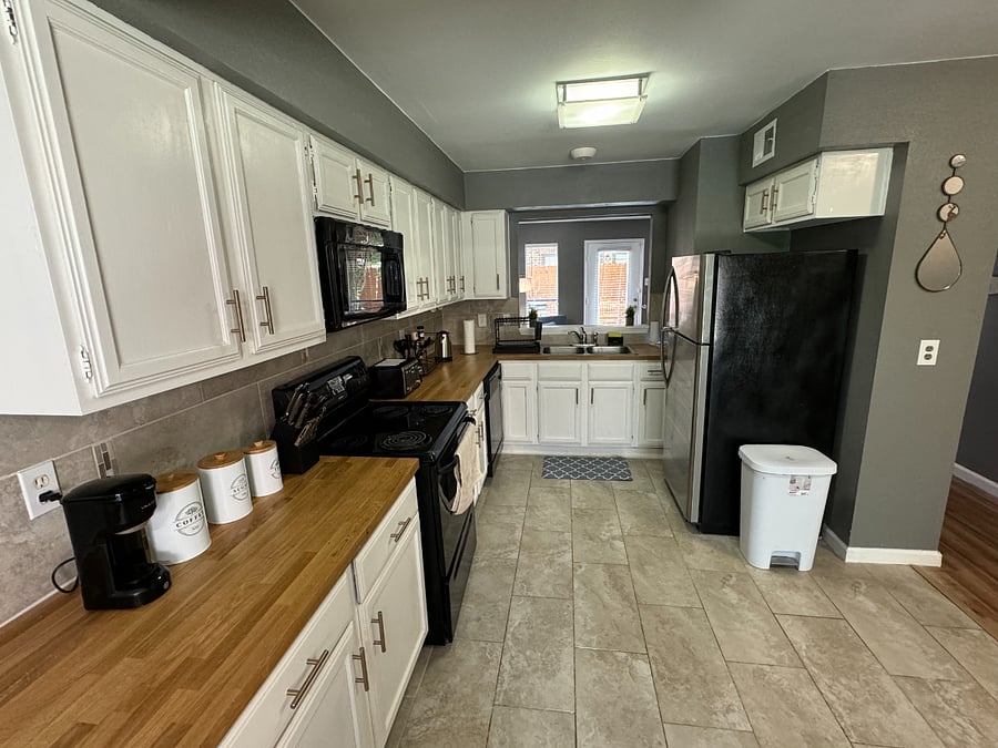 The open plan kitchen flows into the dining room with comfortable seating for 4 and tons of natural light.