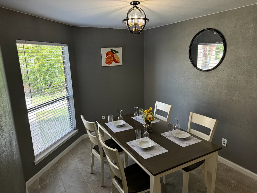 The open plan kitchen flows into the dining room with comfortable seating for 4 and tons of natural light.