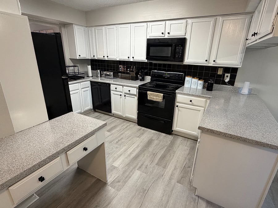 The open plan kitchen flows into the dining room with comfortable seating for 4 and tons of natural light.