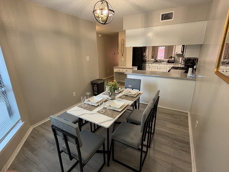 The open plan kitchen flows into the dining room with comfortable seating for 4 and tons of natural light.