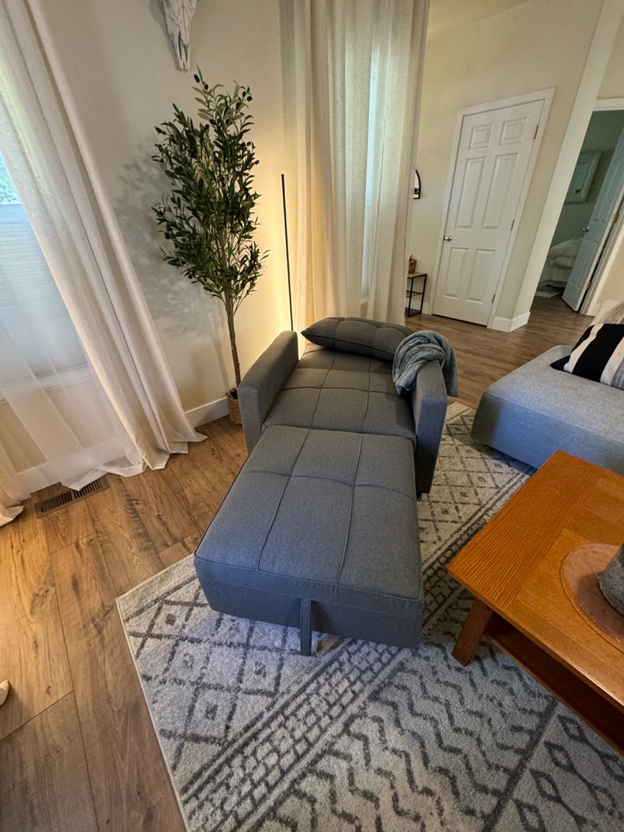 Living room chair flattens for an extra twin