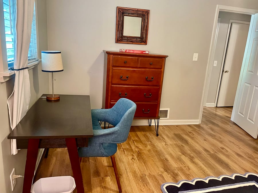 In the full size bedroom there is a desk and chest of drawers