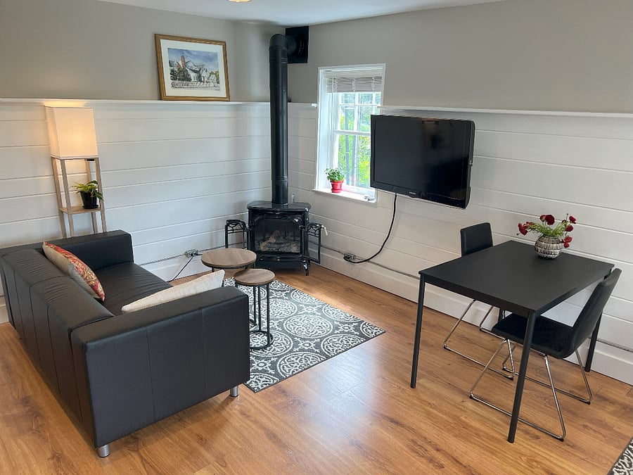 Living space, sofa, gas fireplace, smart tv, dining/computer table