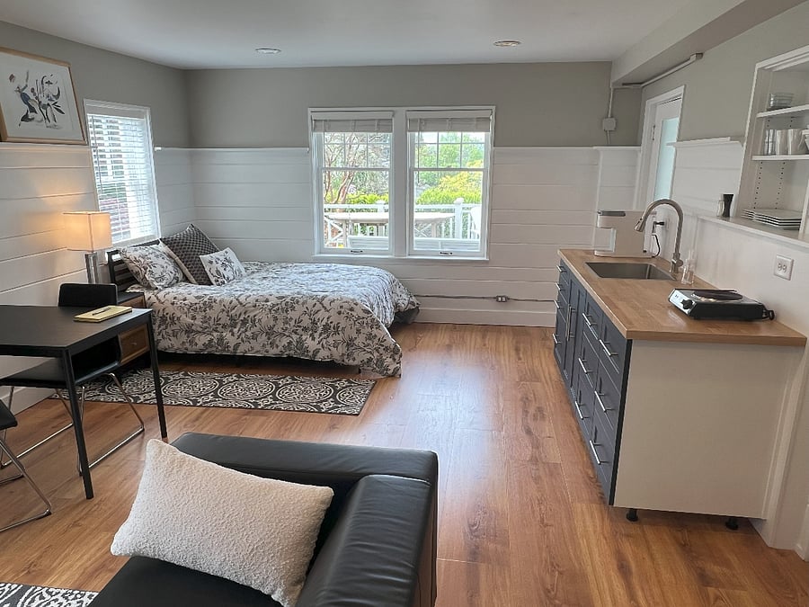 View of bedroom space, kitchen space, and dining / computer table