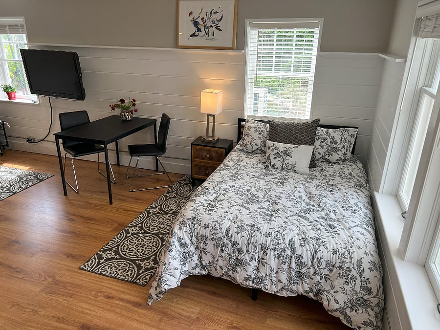 Bedroom space with double bed, and dining / computer table