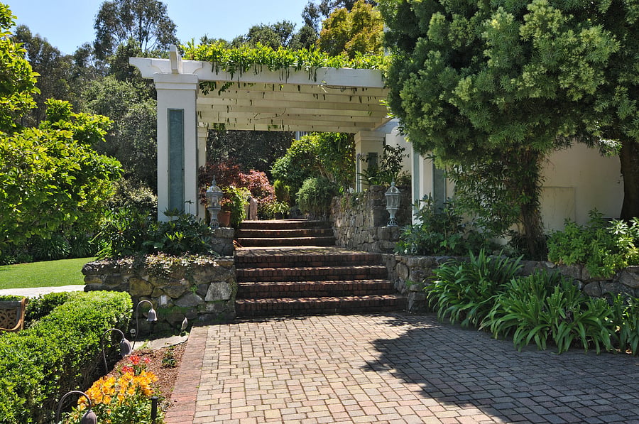 entrance from the street under the wisteria arbor