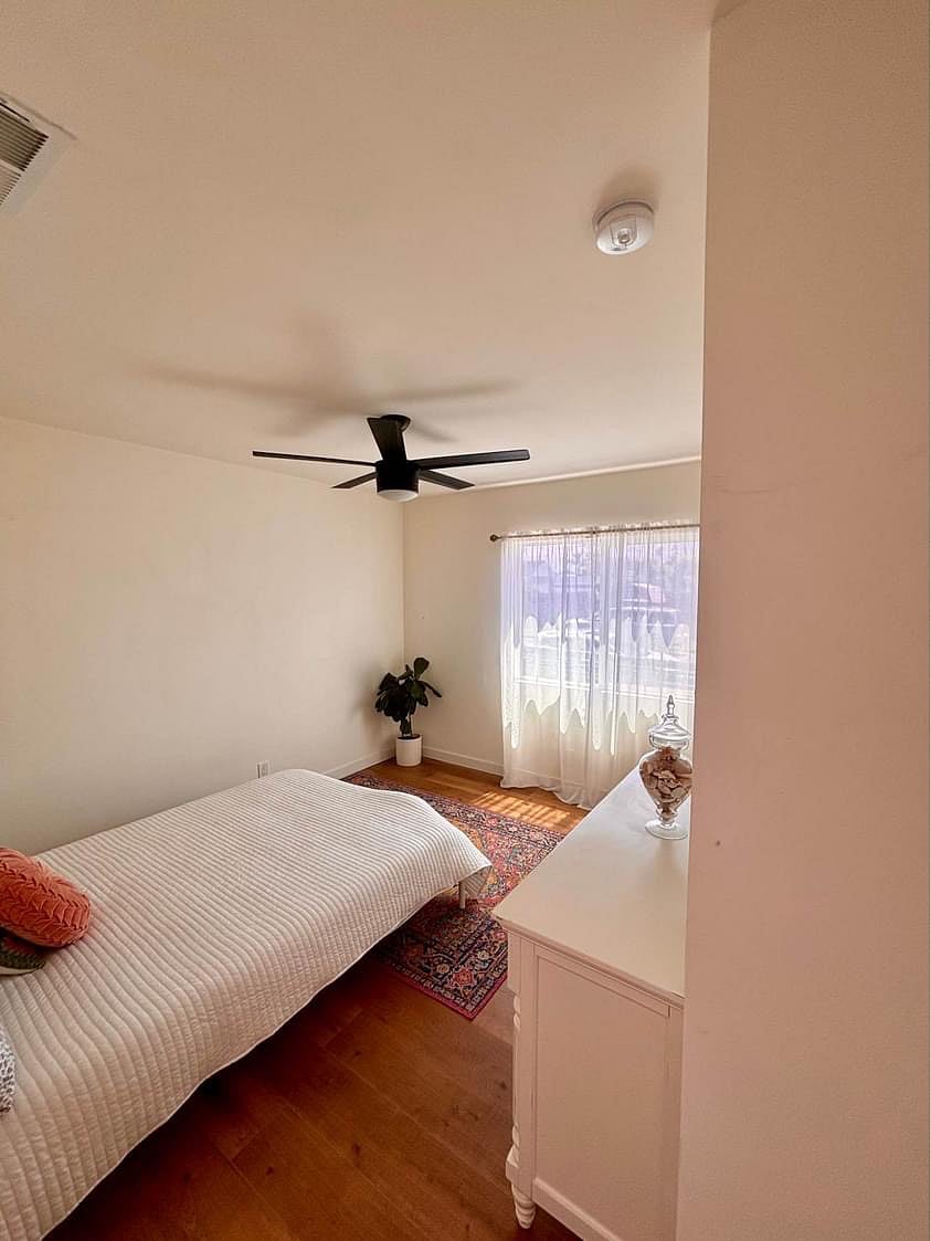 Guest bedroom with a full bed, closet and dresser.