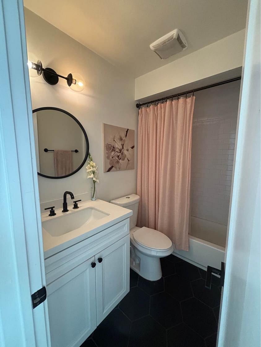 Guest bathroom with tub and shower.