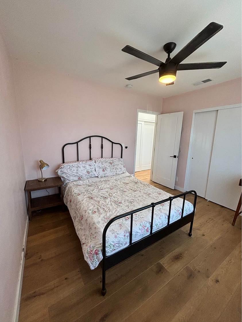 Guest bedroom with dresser and closet.