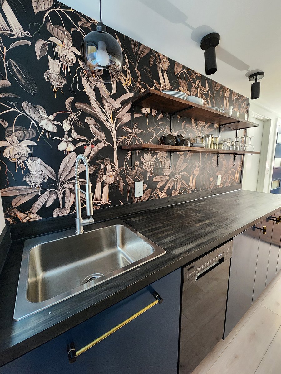 Dishwasher included in the space. Galley kitchen with generous countertop space and lots of natural light due to a large kitchen window next to the sink.