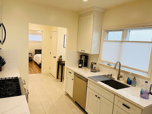 Another view of Kitchen with cabinets and large sink.