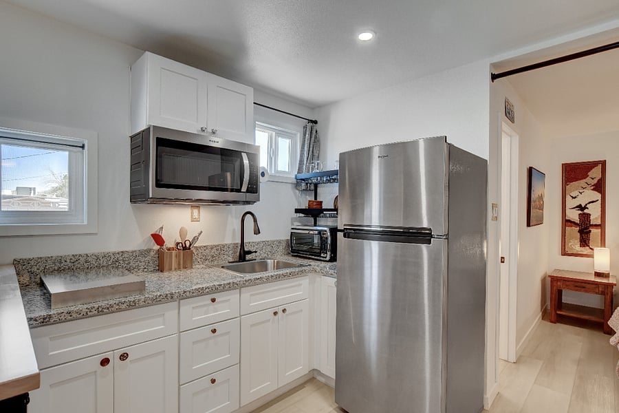 Casita's kitchenette, with bedroom visible beyond the wide doorway