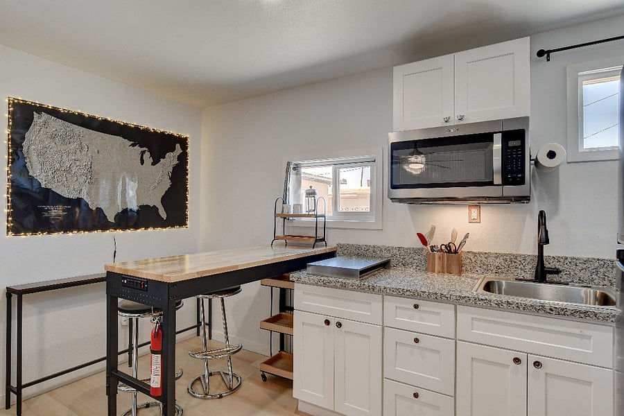 Casita bar height dining and kitchenette with two burner gas stovetop (covered with stainless top)