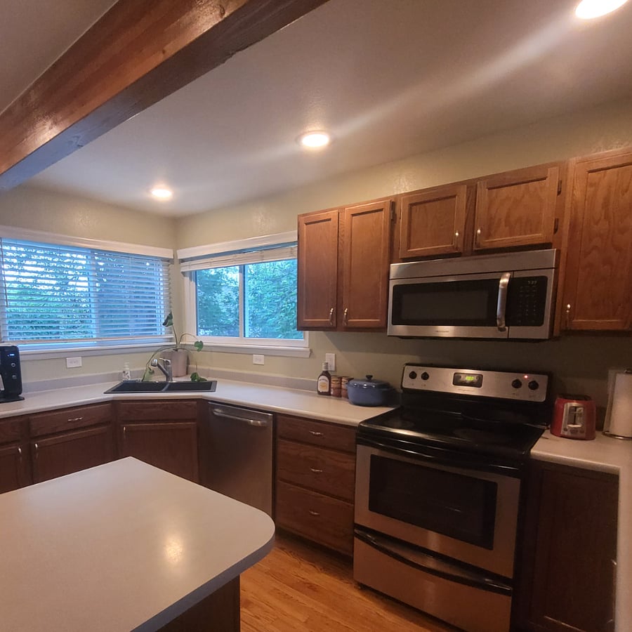 Basement entrance has a door leading up to shared kitchen/dining areas.