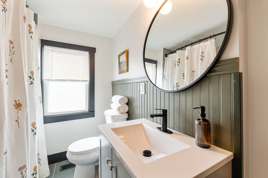 2nd floor bathroom (tub and shower featuring new tile)