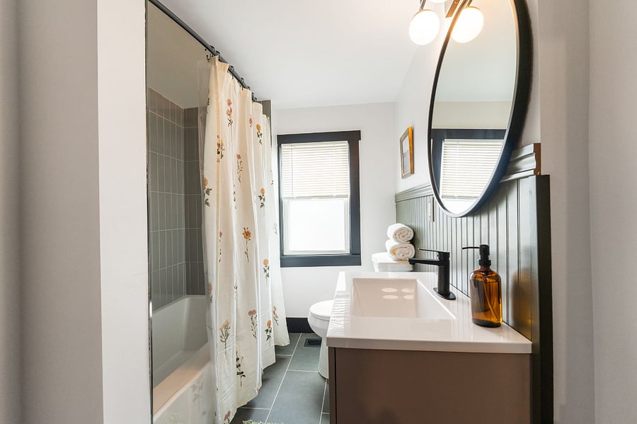 2nd floor bathroom (tub and shower featuring new tile)