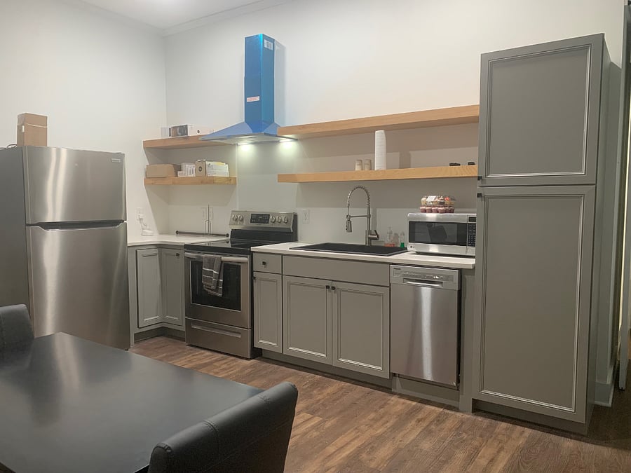 Another view of the kitchen area with open shelving.