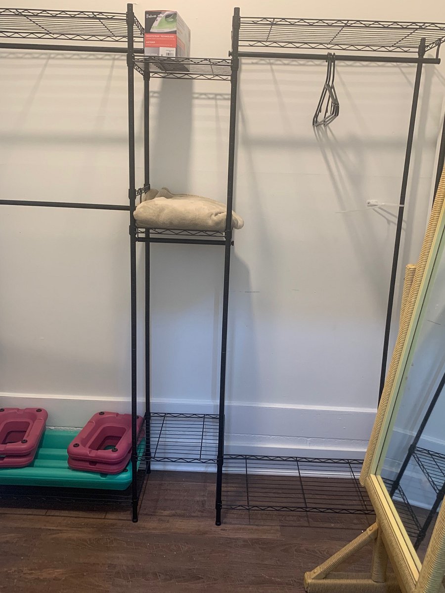 Closet area with lots of storage and mirror for dressing.