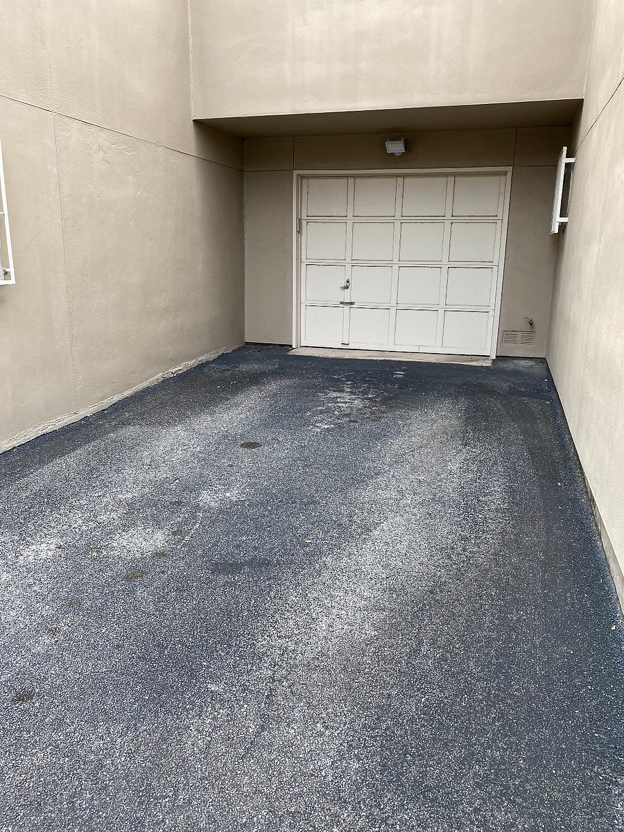 View of back entry (driveway and one-car garage)