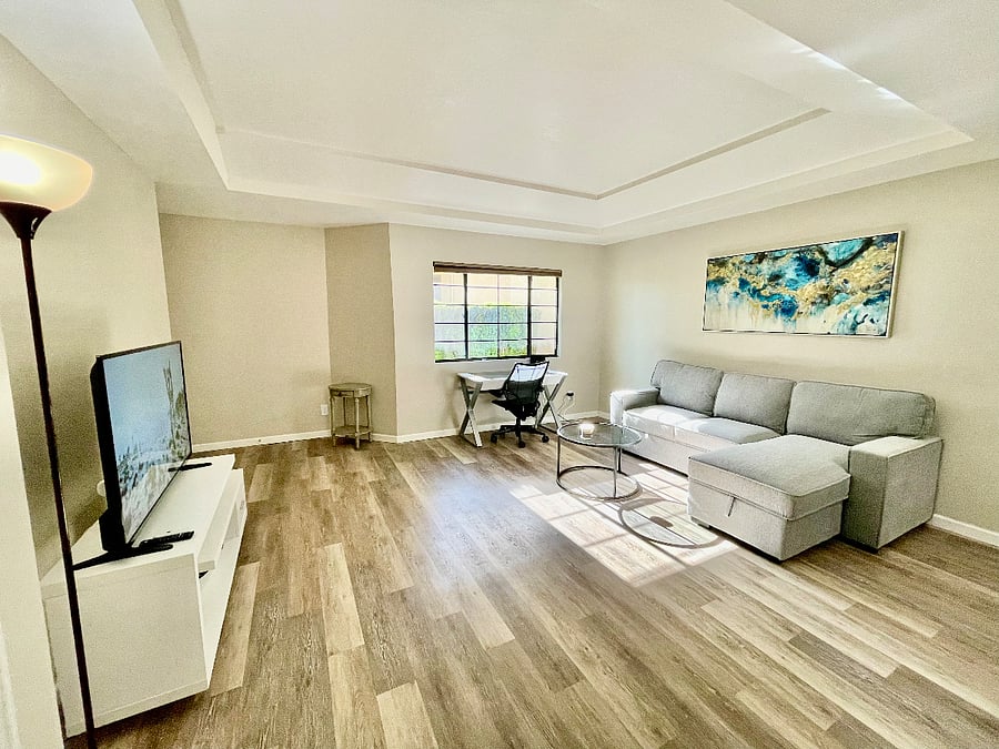 Living Room Area with Convertible Sofabed Couch & Work Desk. 