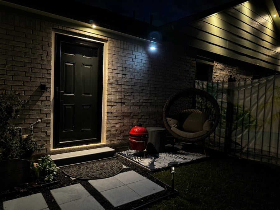 Well lit private patio with grill, egg chair, & table. 