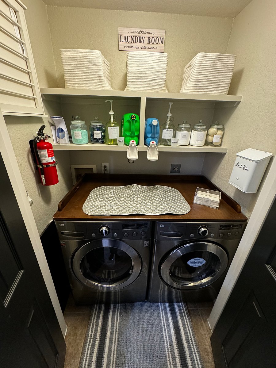 Laundry area has amenities, lint bin, & fire extinguisher. Theres also a pull down rack for items that needs air drying, on the left. 
