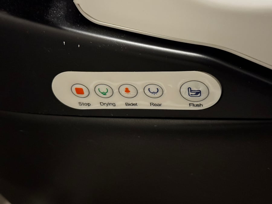 Bidet buttons on the right side of the toilet