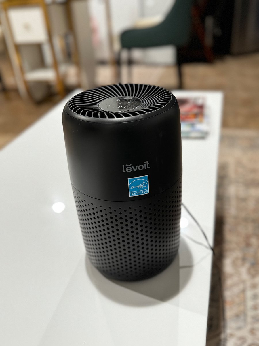 Air purifier located to the right side of the bed. 