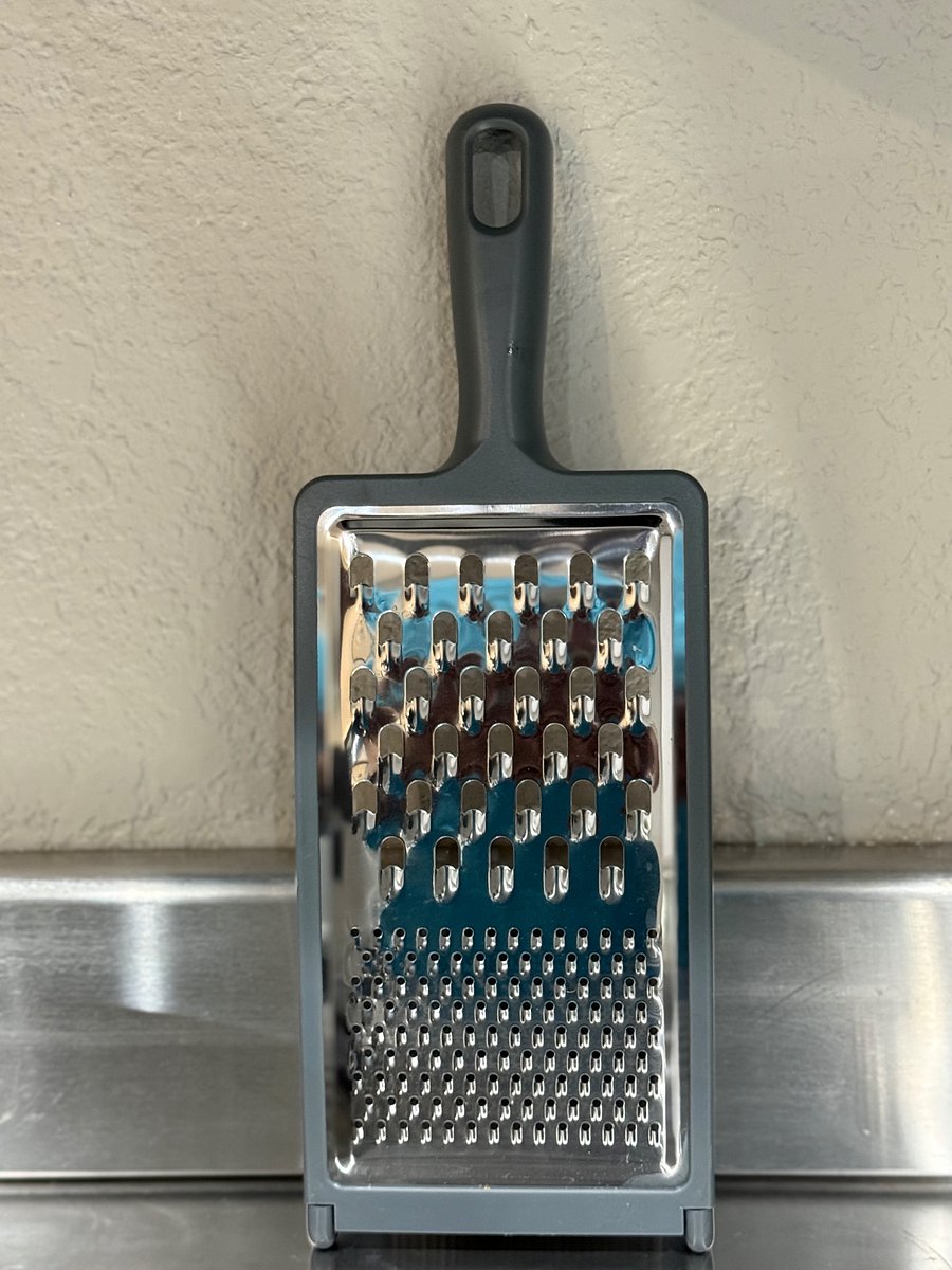Grater kept inside kitchenette storage