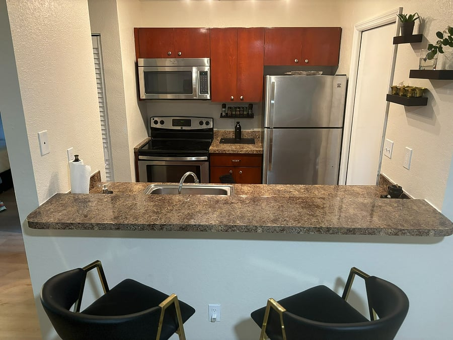 The door next to the refrigerator is the laundry closet with washer and dryer.