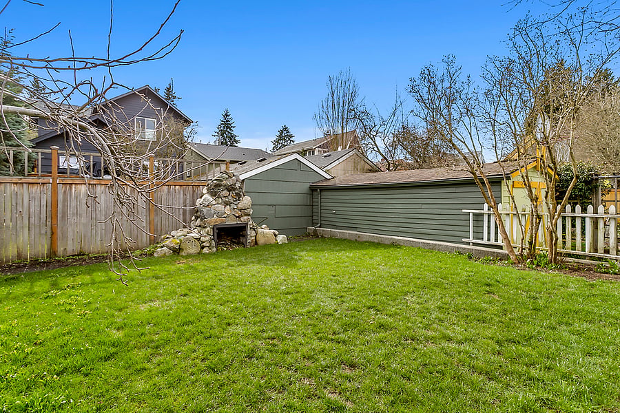 Backyard with 100 year old stone fireplace! 6 lawn chairs not pictured but are included and available to guests to relax