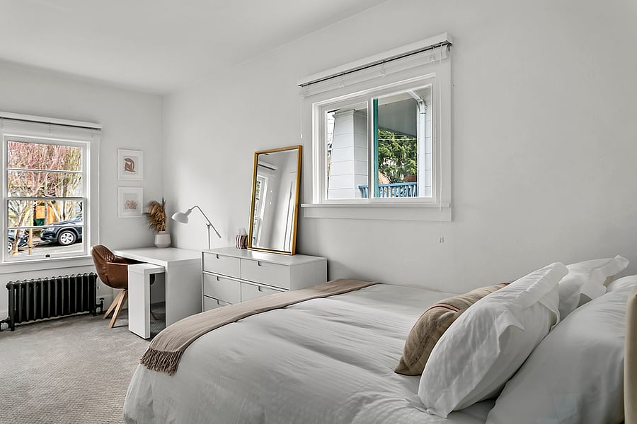 2nd bedroom upstairs w/ work desk, queen bed, dresser & closet space